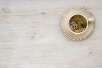 Coffee cup top view on wooden table texture background