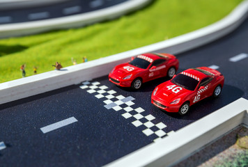Two red toys racing cars