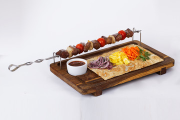 Fototapeta na wymiar kebab skewers of meat on a stick board