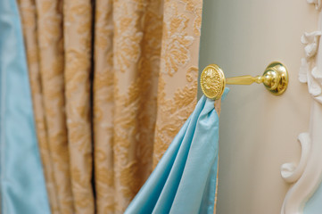 beautiful curtains in the bedroom and a gold holder