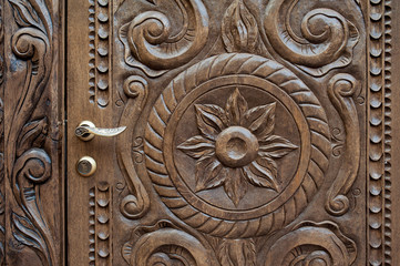Fototapeta premium beautiful ornately carved wooden panel in an antique door