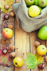 Autumn composition of fruits, nuts and spices - pears, walnuts, maple leaves
