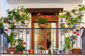 Fototapeta na wymiar Traditional European Balcony with colorful flowers and