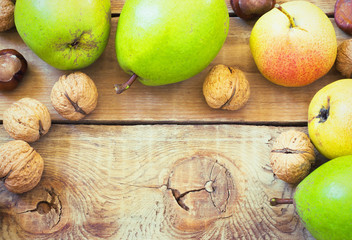 Autumn composition of fruits, nuts and spices - pears, walnuts, maple leaves
