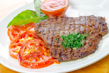 Steak with grilled tomatoes