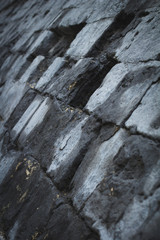 Wall of large black stones