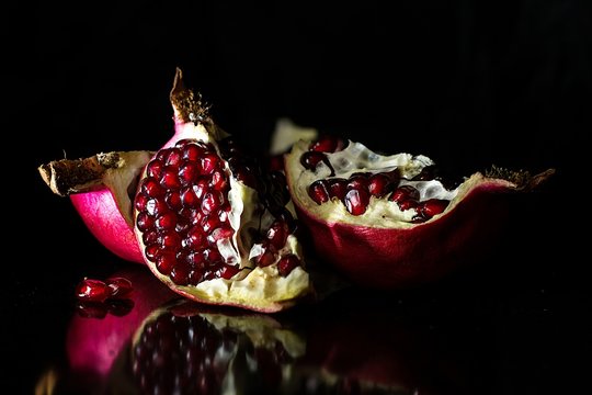 Opened pomegranate in black background