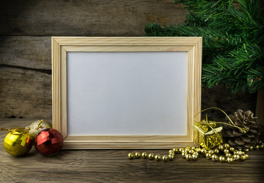 Picture Frame and Christmas decorations on old wooden background