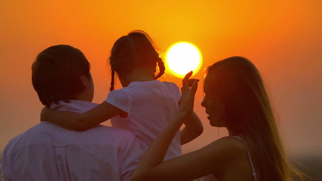 6 in 1 video! The family (father, mother and daughter) by sunset background. Real time capture. Shot with Red Cinema Camera