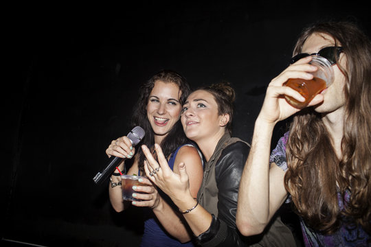 Friends doing karaoke at a nightclub