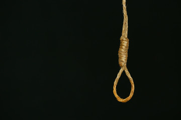 bankrupt concept, rope noose with hangman's knot hanging in front, Halloween background.