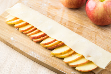 Slices of apple and crust - ingredients for apple roses pie.