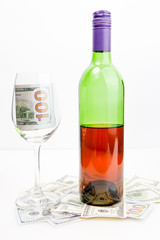 Bottle of wine,dollars and glass isolated on white.