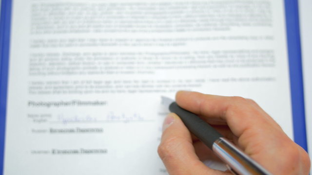 Camera follow the arm! The businessman signs the contract, view without face. S
