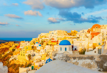 Santorini in the early morning with yellow sunlight over the city, Mediterranean sea, Greece