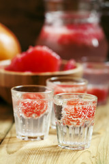 Soda with pink grapefruit in glasses on an old wooden table, sel