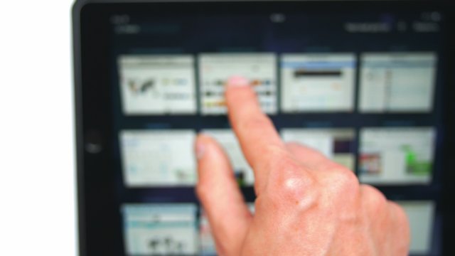 The hand (finger) work with touchscreen (ipad)  by white background