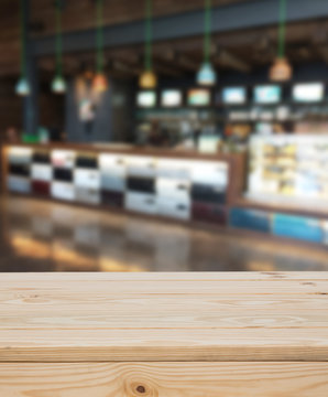 Wood table with blur coffee shop background