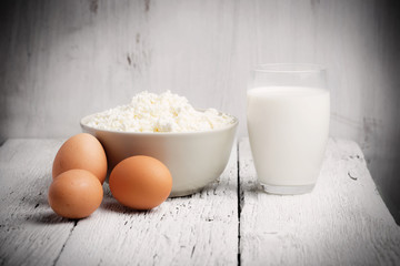 Fresh dairy products and eggs on rustic wooden table