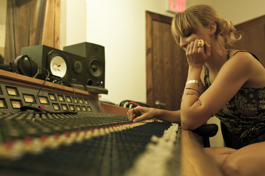 Portrait of a young woman in a recording studio