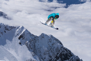 Flying snowboarder on mountains
