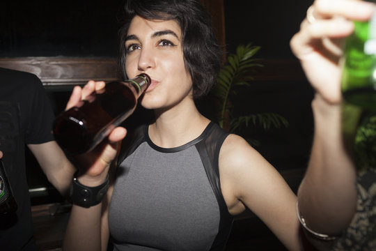Woman enjoying beer at a party