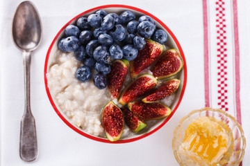 Oatmeal with seiram,blueberries and honey.Healthy Breakfast.selective focus