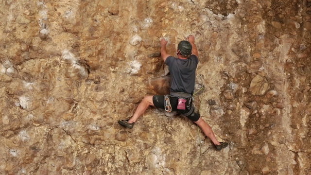 Man climbs rock wall Maple Box Canyon Utah HD 2697