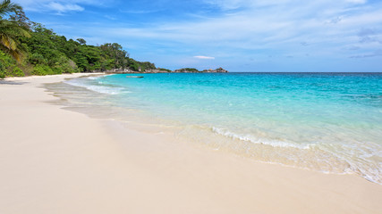 Fototapeta na wymiar Beautiful landscape of blue sky sea sand and white waves on the beach during summer at Koh Miang island in Mu Ko Similan National Park, Phang Nga province, Thailand, 16:9 widescreen