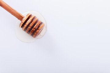 Honey dipper on a white background.Copy space. selective focus.