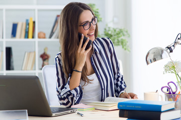 Beautiful young woman working in the office.