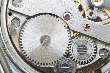 Metal cogwheels inside clockwork. Macro.