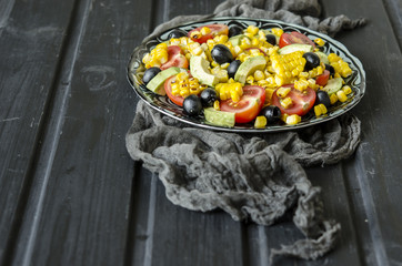 Salad with tomatoes and olives avocado grilled corn with mayonnaise   