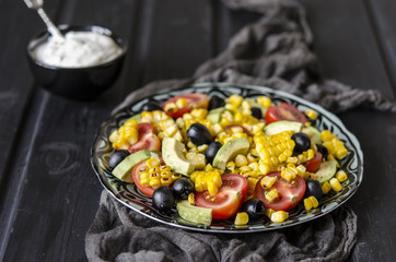 Salad with tomatoes and olives avocado grilled corn with mayonnaise   