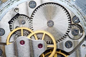 Fototapeta na wymiar Metal cogwheels inside clockwork. Macro.