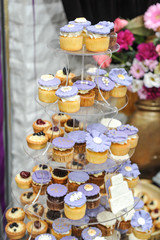 Wedding decoration with pastel colored cupcakes, meringues, muffins and macarons. Elegant and luxurious event arrangement with colorful macaroons. 