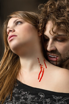 girl bitten by a vampire with bloody mouth 