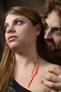 vampire bites the neck of a girl