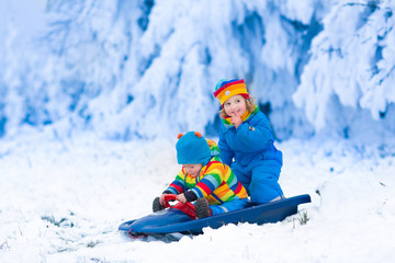 Fototapeta na wymiar Kids having fun on a sleigh ride in winter
