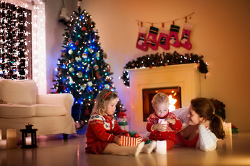 Fototapeta na wymiar Family at fireplace on Christmas eve