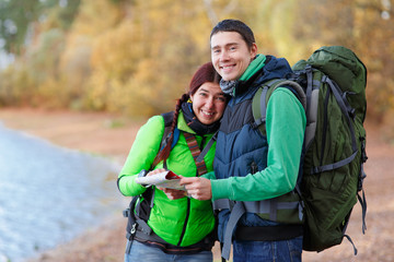 Happy couple going on a hike together in a forest