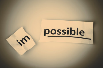 The word impossible changed to possible on torn paper