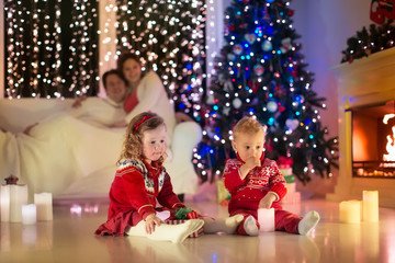 Fototapeta na wymiar Family with kids celebrating Christmas at home