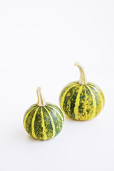 Decorative small pumpkins with stripes isolated on white