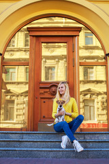 girl with a jack russell terrier dog sitting on the steps