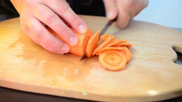 The cook cuts carrots