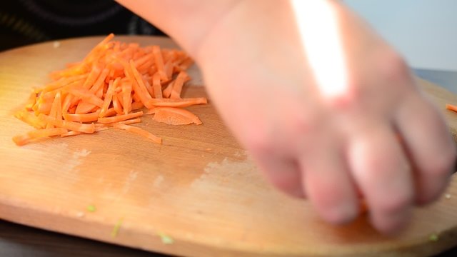 The cook cuts carrots