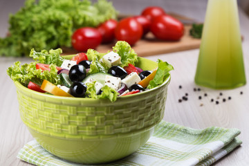 Greek salad with fresh vegetables, feta cheese and black olives