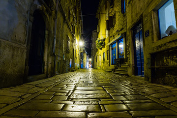 Narrow street in night of old town of Rovinj, Croatia