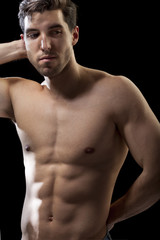 Fototapeta na wymiar muscular torso of man on black bakground